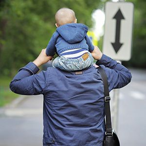 man holding son on shoulders